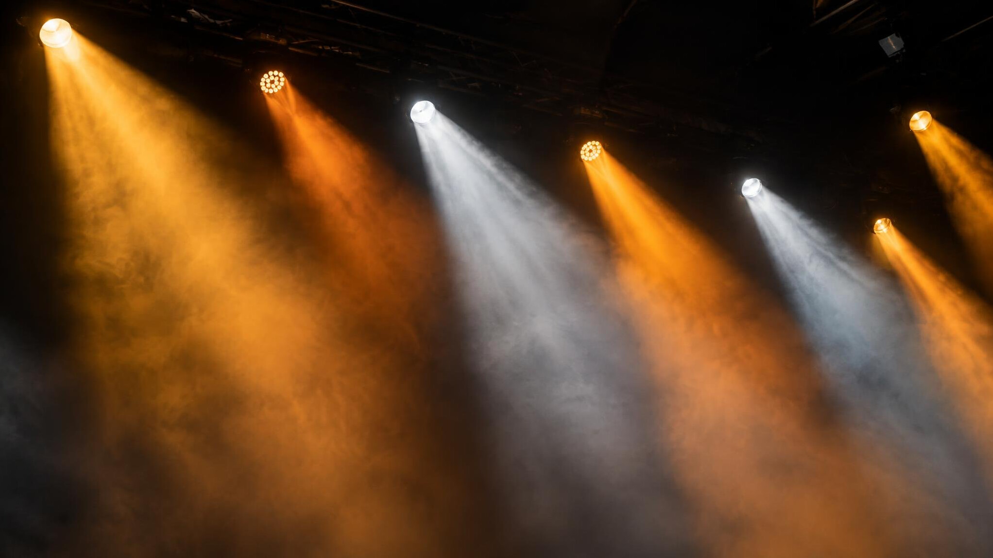 Stage spotlights shining through haze